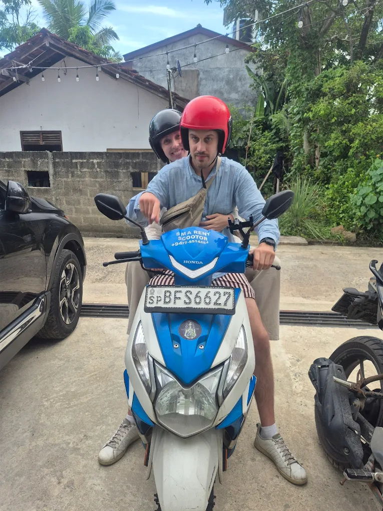 Happy tourist couple riding SMA branded scooter